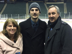 Connor with his father and mother in hockey arena