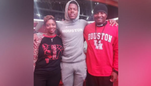 Picture of Marcus with his basketball player father and very supportive mother