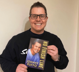 Johnny Ruffo with his book