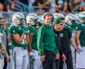 The most successful head coach in the history of Dartmouth football was Buddy Teevens, as seen on the sidelines during a game against Yale.